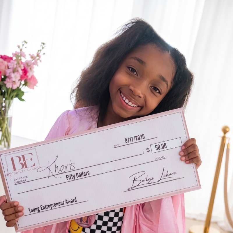 MI-IMPACT-Girl-holding-50-dollar-check-from-winning-young-entrepreneur-award-Detroit-Michigan-alternative-homeschool-online-school-programs